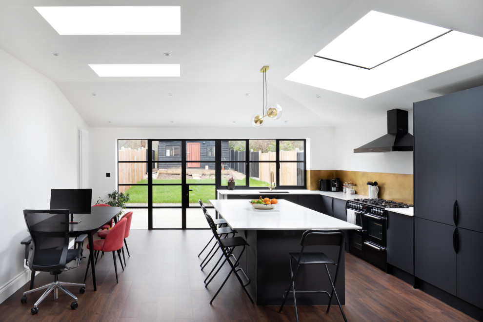 Inspiration for a contemporary open plan kitchen in London with a peninsula.