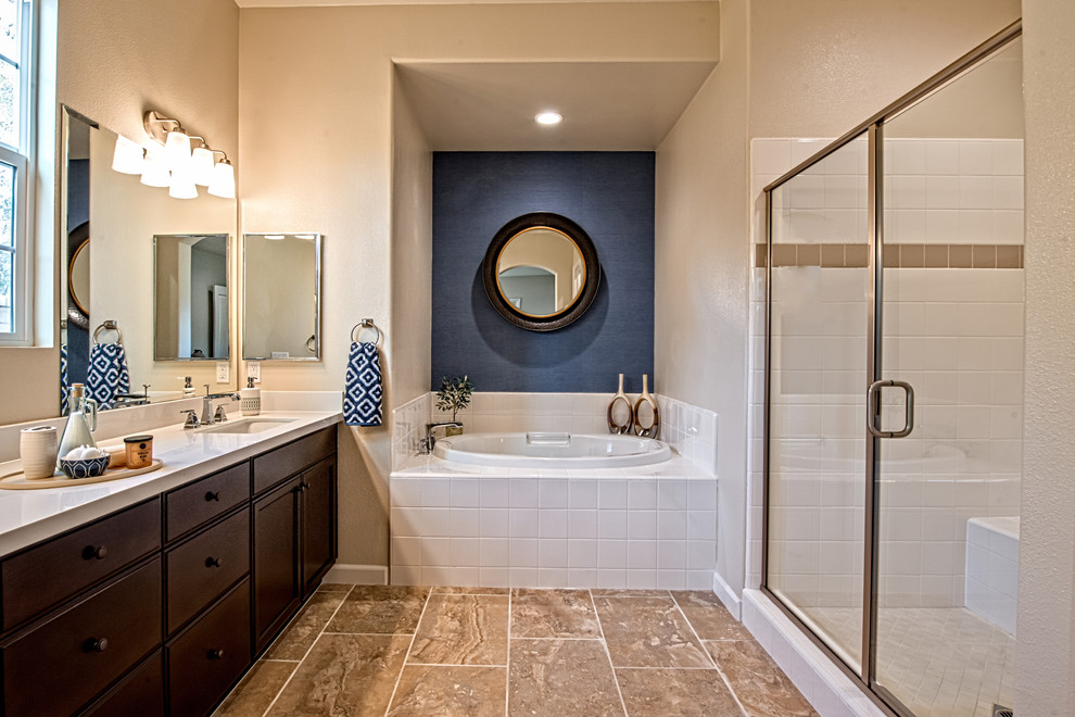 Design ideas for a large transitional master bathroom in Los Angeles with recessed-panel cabinets, brown cabinets, a drop-in tub, an alcove shower, beige tile, porcelain tile, beige walls, porcelain floors, an undermount sink, engineered quartz benchtops, brown floor, a hinged shower door and white benchtops.
