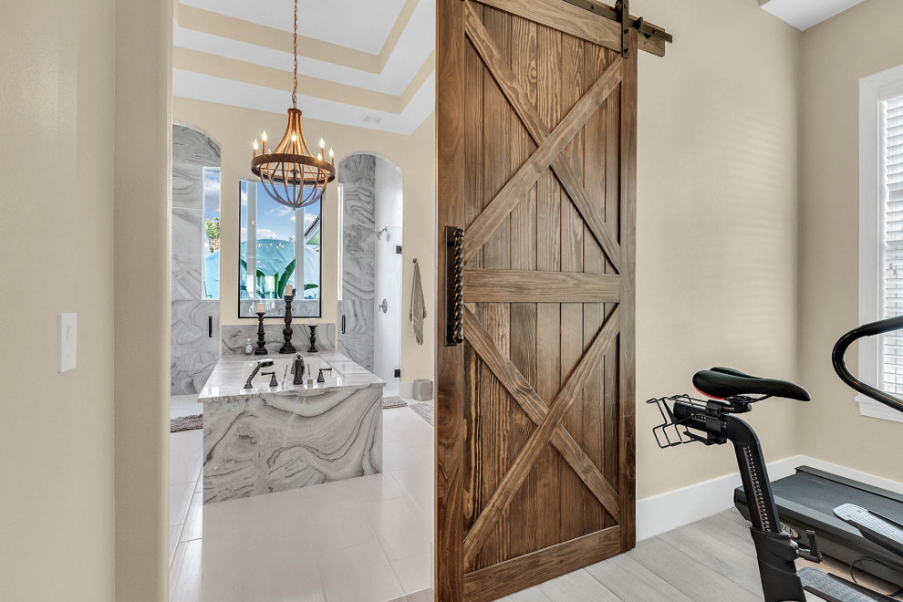 This is an example of a mid-sized transitional master bathroom in Orlando with shaker cabinets, beige cabinets, a freestanding tub, an open shower, a one-piece toilet, multi-coloured tile, marble, grey walls, porcelain floors, an undermount sink, onyx benchtops, grey floor, an open shower and multi-coloured benchtops.