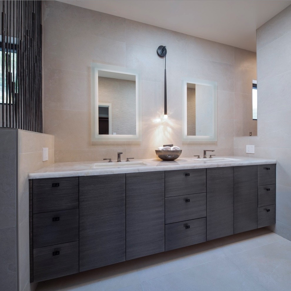 This is an example of a mid-sized modern master bathroom in San Francisco with flat-panel cabinets, medium wood cabinets, a curbless shower, a one-piece toilet, gray tile, ceramic tile, grey walls, ceramic floors, an undermount sink, quartzite benchtops, grey floor, an open shower and beige benchtops.