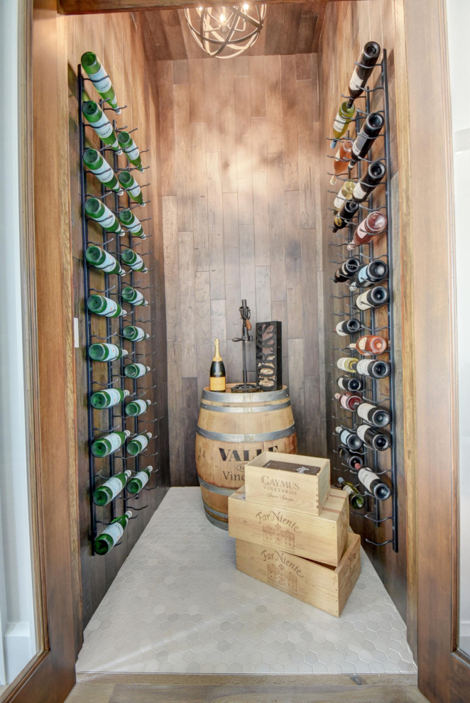 Design ideas for a mid-sized beach style wine cellar in Other with porcelain floors and white floor.