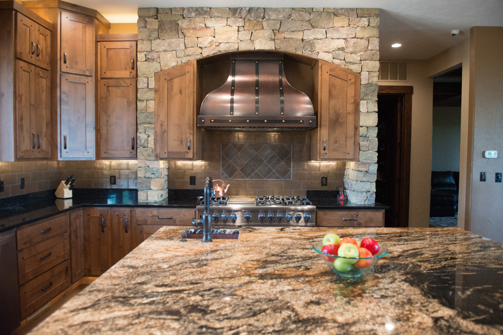 Example of a huge mountain style u-shaped medium tone wood floor eat-in kitchen design with a double-bowl sink, shaker cabinets, medium tone wood cabinets, granite countertops, metallic backsplash, stainless steel appliances and two islands