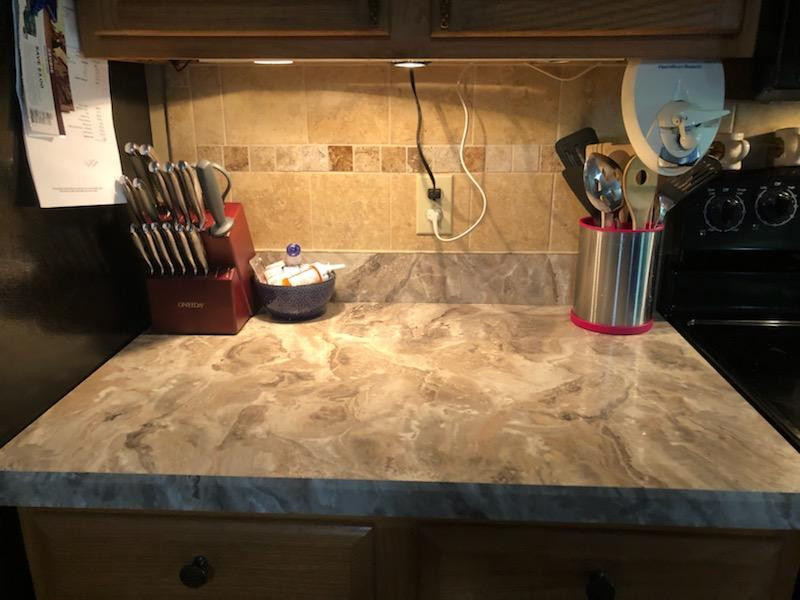 Example of a mid-sized kitchen design with laminate countertops and gray countertops