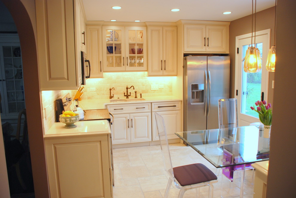 Mid-sized eclectic l-shaped eat-in kitchen in Chicago with raised-panel cabinets, beige cabinets, quartz benchtops, beige splashback, stone tile splashback, stainless steel appliances, no island and beige floor.