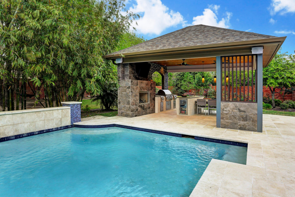 This is an example of a mid-sized traditional backyard patio in Houston with an outdoor kitchen, tile and a gazebo/cabana.