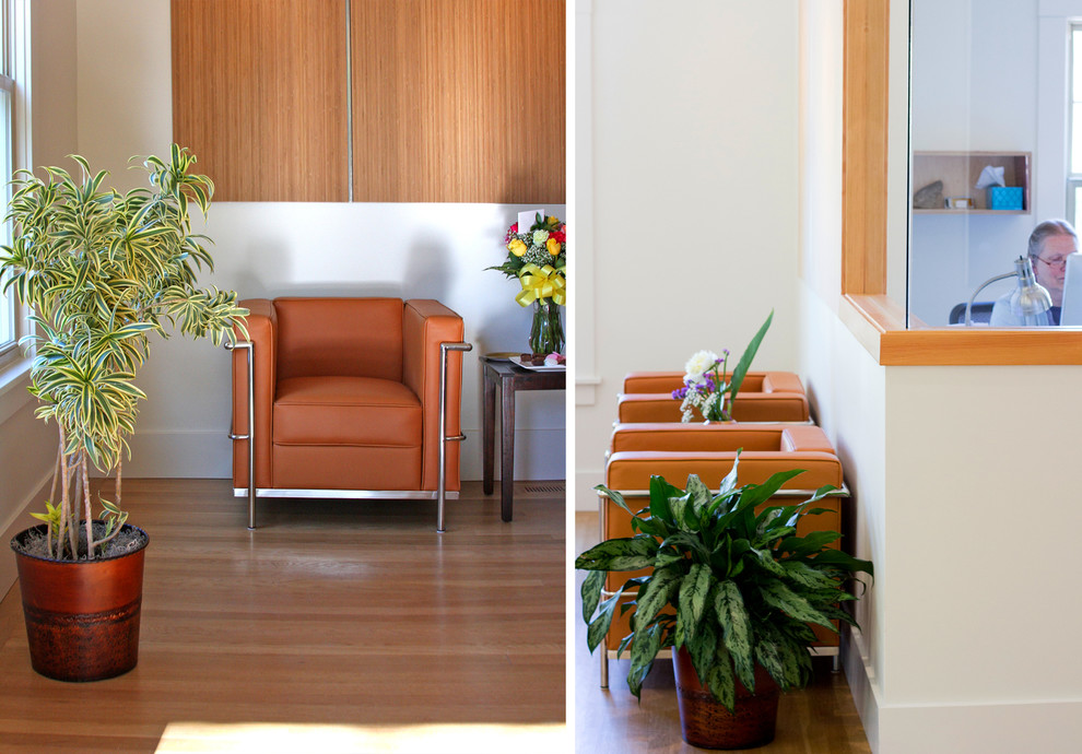 Light wood floor foyer photo with white walls