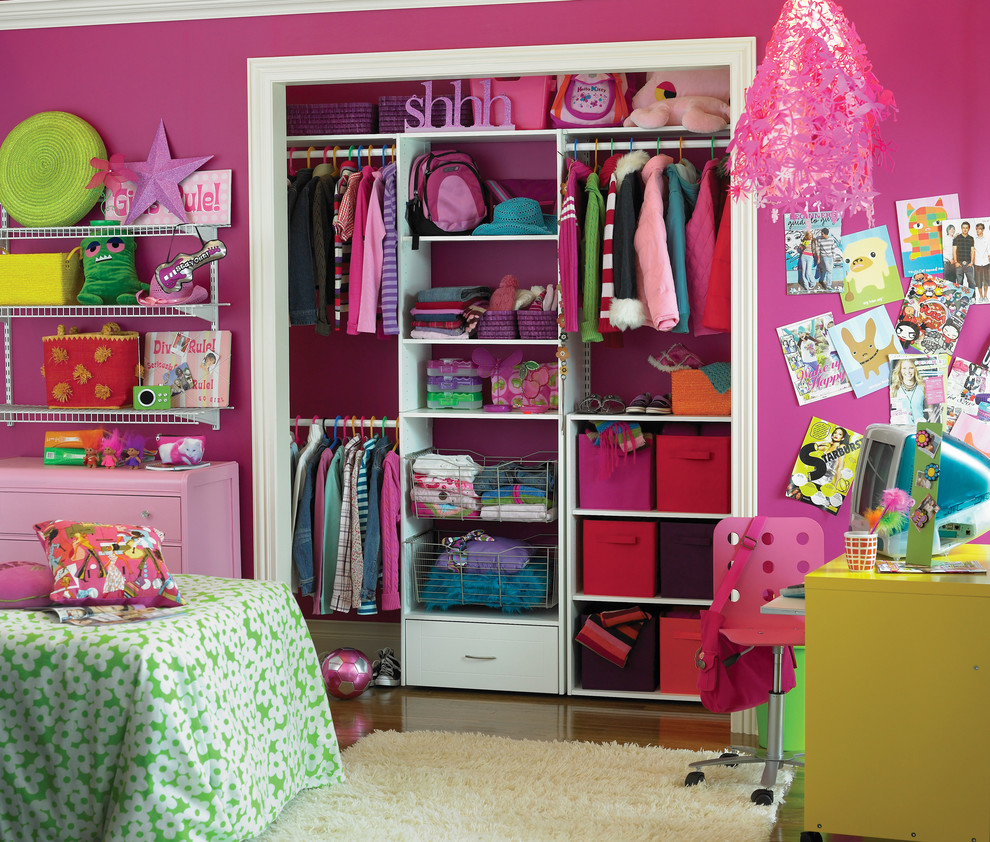 This is an example of an eclectic kids' room for girls in Other with pink walls.