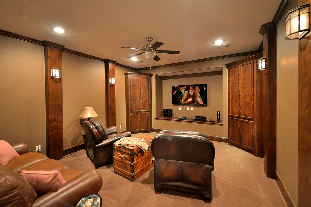 Photo of a mid-sized arts and crafts enclosed home theatre in Phoenix with brown walls, carpet and a wall-mounted tv.