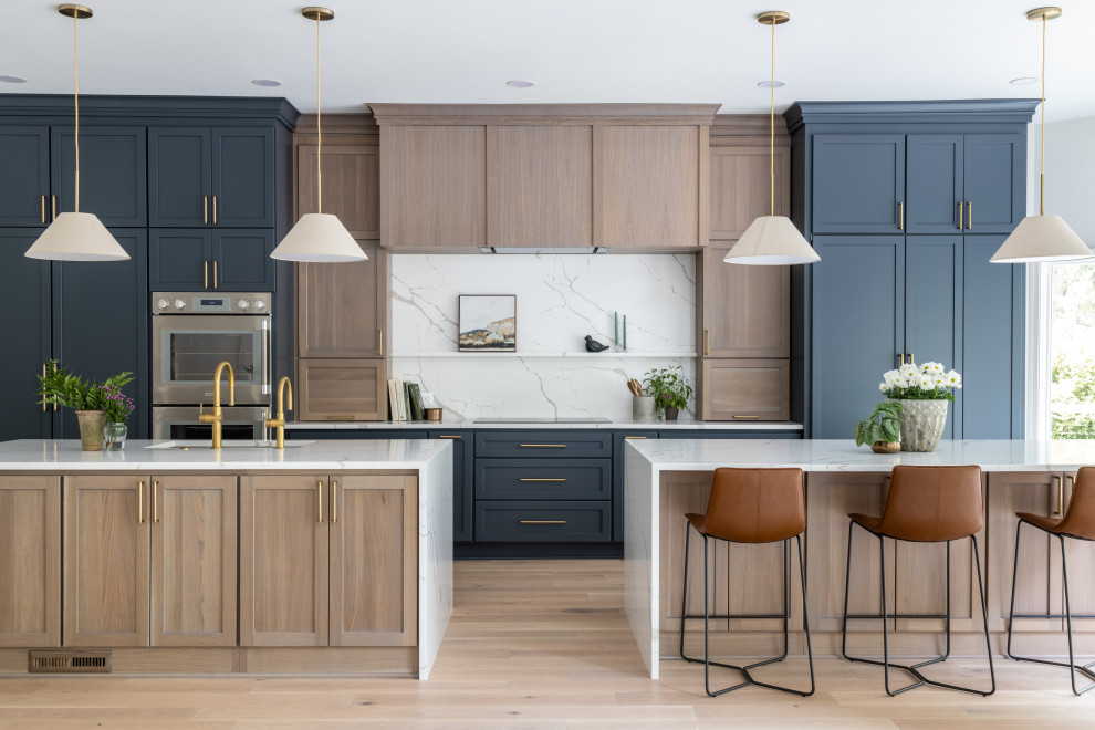 Kitchen - transitional kitchen idea in DC Metro with a drop-in sink, quartzite countertops, white backsplash, quartz backsplash, stainless steel appliances, two islands and white countertops
