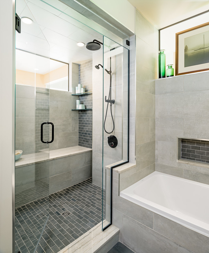 Design ideas for a mid-sized modern 3/4 bathroom in Ottawa with a vessel sink, medium wood cabinets, marble benchtops, a drop-in tub, a corner shower, a one-piece toilet, gray tile and beige walls.