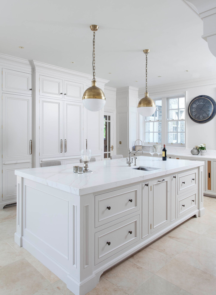Design ideas for a large traditional u-shaped open plan kitchen in Other with a drop-in sink, beaded inset cabinets, white cabinets, marble benchtops, white splashback, marble splashback, stainless steel appliances, porcelain floors, with island, beige floor and yellow benchtop.