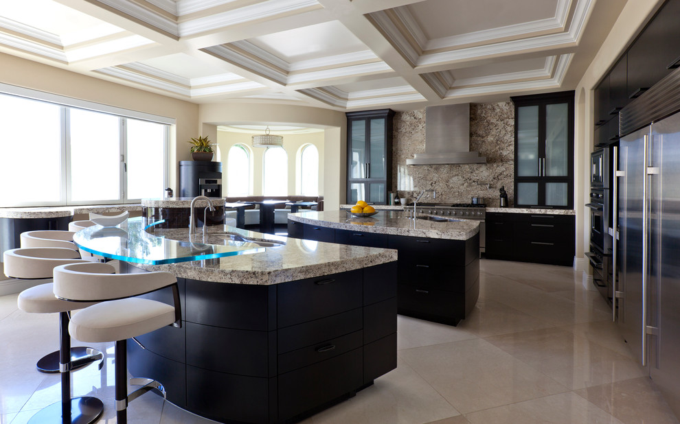 This is an example of an expansive contemporary single-wall eat-in kitchen in Phoenix with an undermount sink, flat-panel cabinets, black cabinets, granite benchtops, brown splashback, stone slab splashback, stainless steel appliances, marble floors, multiple islands, beige floor and brown benchtop.