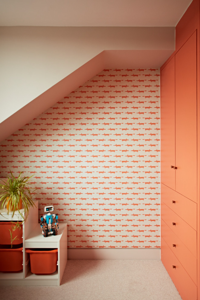 Inspiration for a small scandi gender neutral kids' bedroom in Sussex with orange walls, carpet, beige floors, a vaulted ceiling, wallpapered walls and a feature wall.