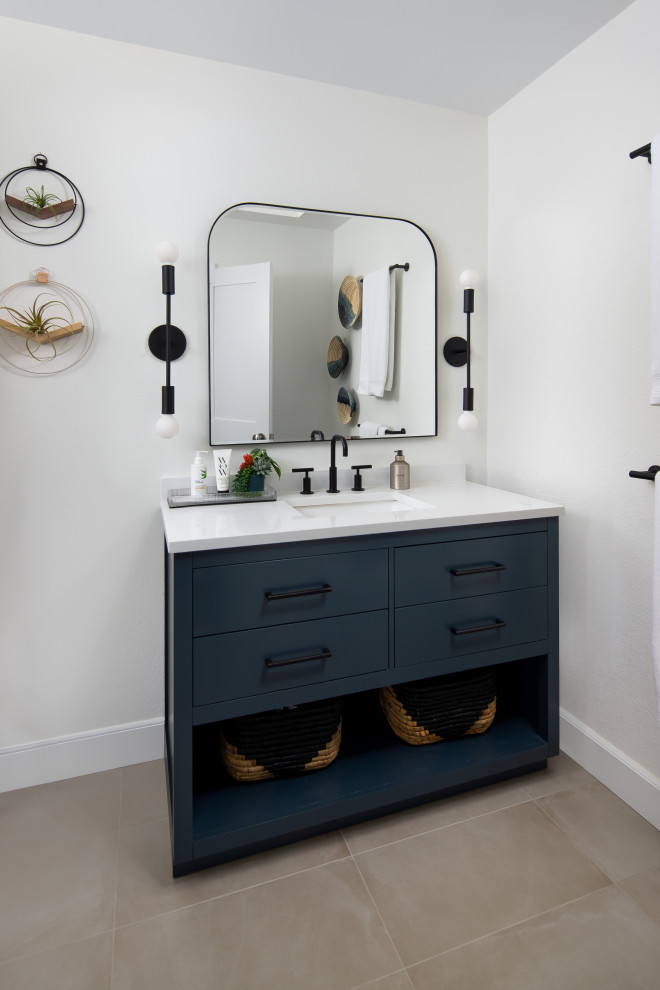 Inspiration for a mid-sized coastal kids' white tile and ceramic tile ceramic tile, gray floor and single-sink bathroom remodel in San Diego with flat-panel cabinets, blue cabinets, a one-piece toilet, white walls, an undermount sink, quartz countertops, white countertops, a niche and a freestanding vanity