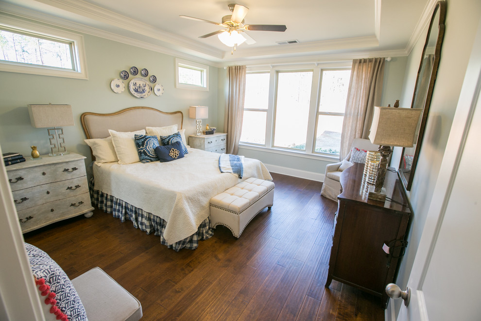 This is an example of a large transitional master bedroom in Atlanta with grey walls and medium hardwood floors.