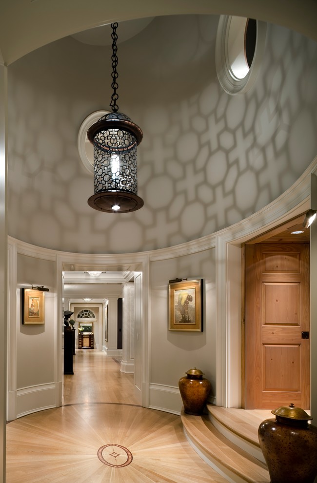 Inspiration for a traditional foyer in Other with grey walls and light hardwood floors.