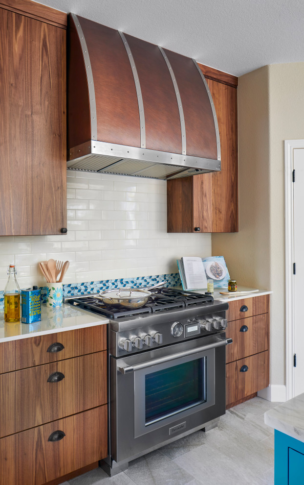 Inspiration for a mid-sized transitional u-shaped porcelain tile and white floor eat-in kitchen remodel in Denver with a double-bowl sink, flat-panel cabinets, medium tone wood cabinets, quartzite countertops, multicolored backsplash, ceramic backsplash, stainless steel appliances, an island and white countertops