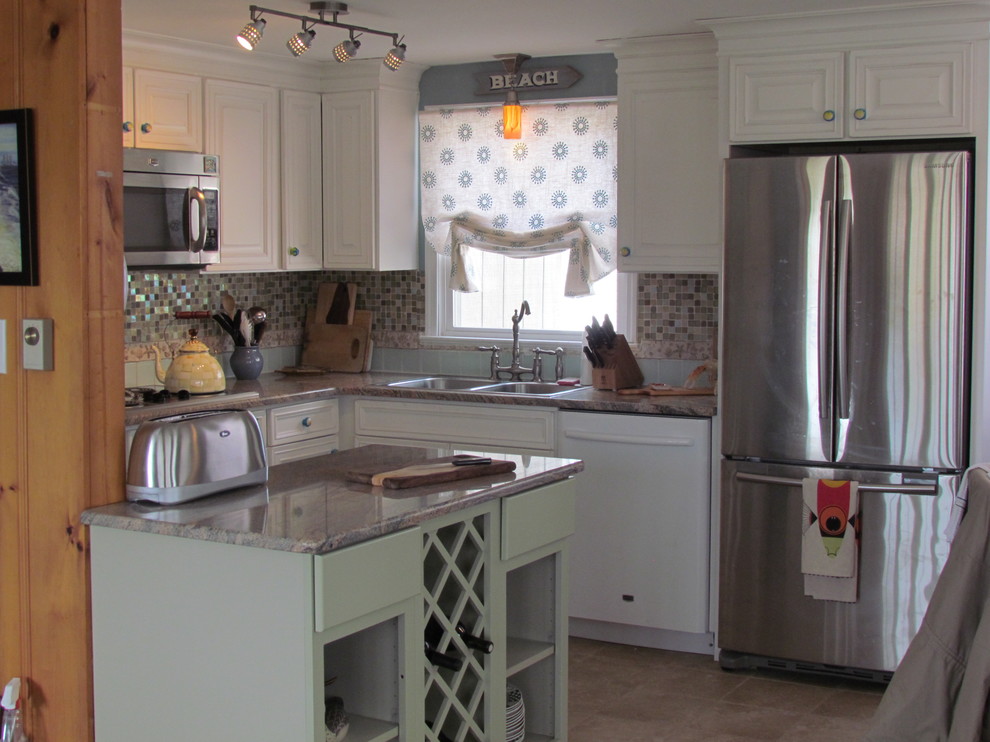 Photo of a small beach style l-shaped eat-in kitchen in New York with a drop-in sink, beaded inset cabinets, white cabinets, granite benchtops, multi-coloured splashback, mosaic tile splashback, stainless steel appliances and porcelain floors.
