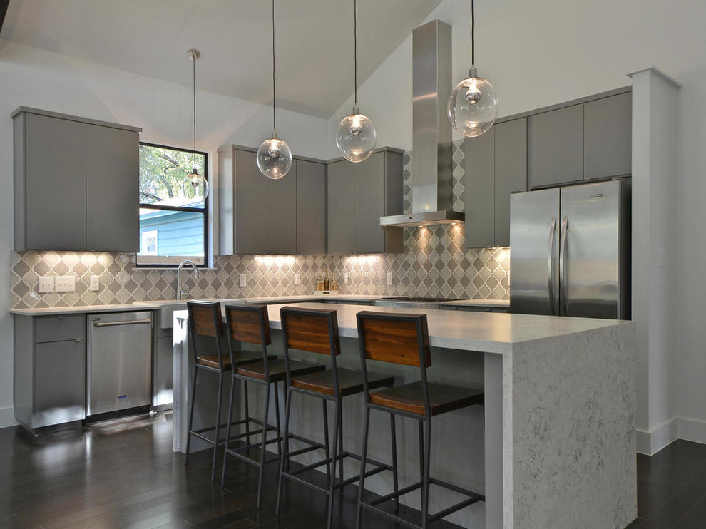 Small trendy l-shaped dark wood floor eat-in kitchen photo in Austin with a farmhouse sink, flat-panel cabinets, gray cabinets, quartzite countertops, multicolored backsplash, ceramic backsplash, stainless steel appliances and an island