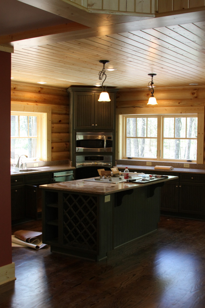 Enclosed kitchen - mid-sized l-shaped dark wood floor, brown floor and wood ceiling enclosed kitchen idea with a double-bowl sink, dark wood cabinets, stainless steel appliances, an island and brown countertops