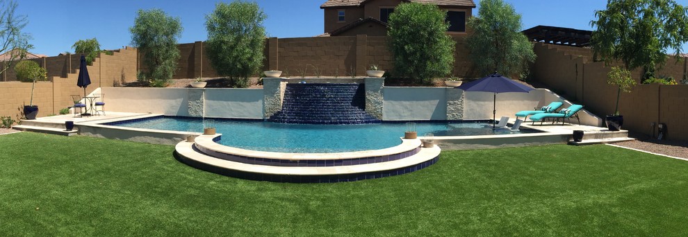 Example of a large transitional backyard stone and rectangular lap pool fountain design in Phoenix