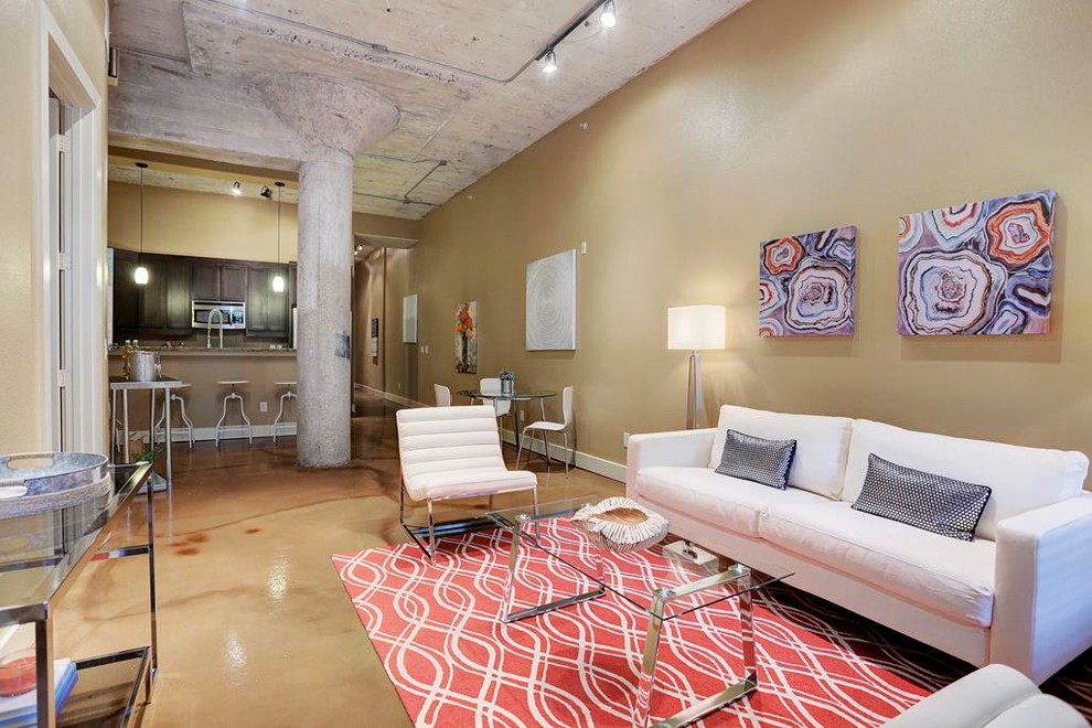 Mid-sized industrial open concept living room in Houston with beige walls, concrete floors, no fireplace, no tv and beige floor.