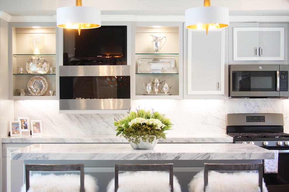 Inspiration for a mid-sized transitional galley open concept kitchen remodel with recessed-panel cabinets, gray cabinets, marble countertops, white backsplash, stone slab backsplash, stainless steel appliances and an island