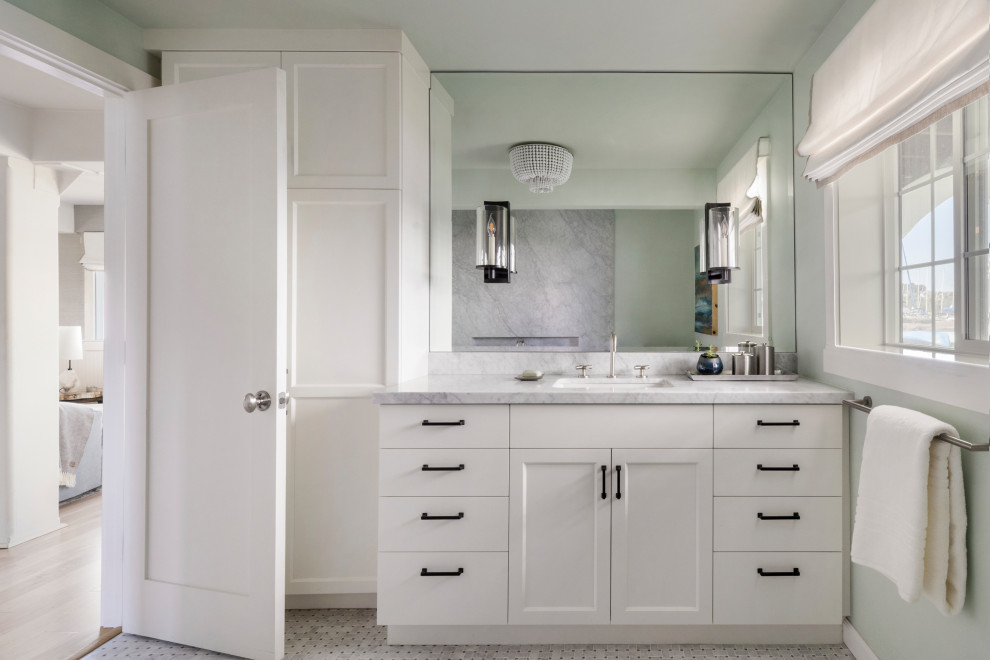 Inspiration for a mid-sized beach style master bathroom in San Francisco with flat-panel cabinets, white cabinets, a freestanding tub, a wall-mount toilet, mosaic tile floors, a single vanity and a built-in vanity.