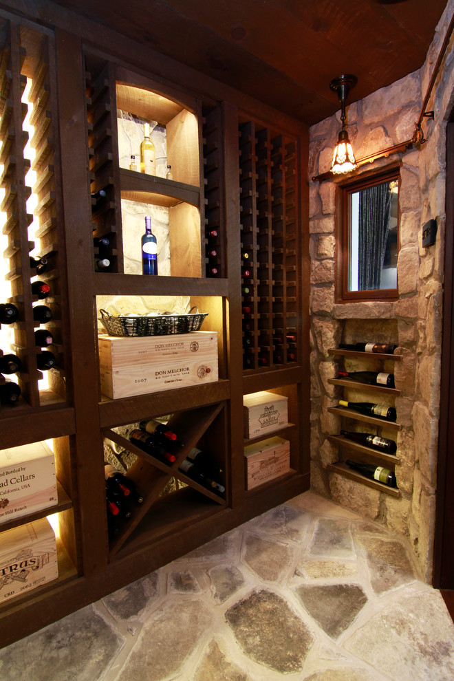 Photo of a mid-sized country wine cellar in Toronto with slate floors and storage racks.