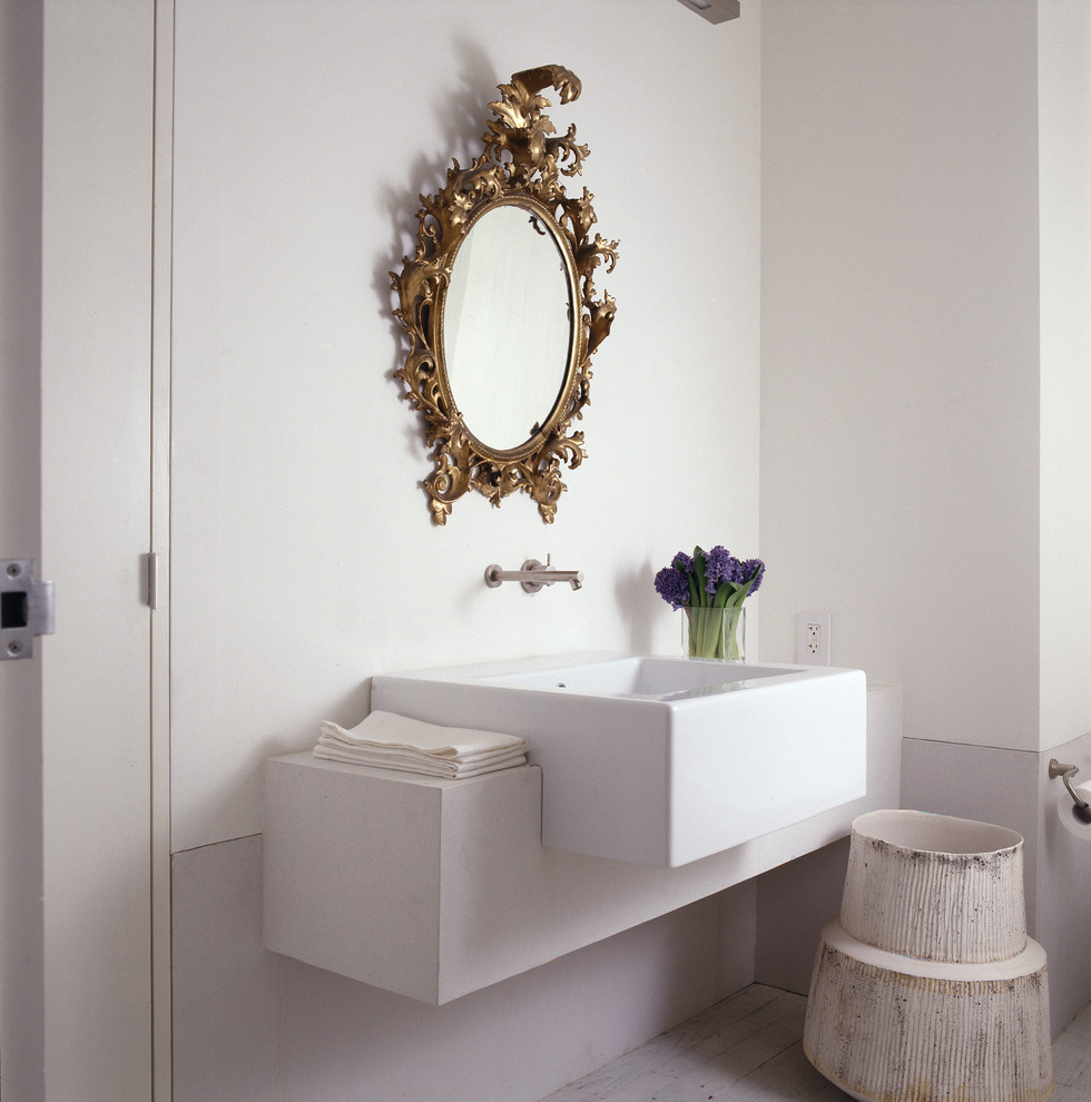 This is an example of a contemporary powder room in DC Metro with a wall-mount sink.