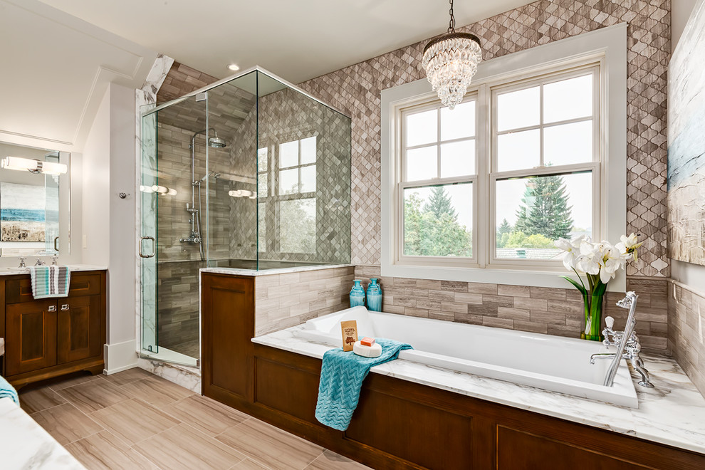 Design ideas for a mid-sized arts and crafts master bathroom in Calgary with a drop-in sink, shaker cabinets, medium wood cabinets, marble benchtops, a drop-in tub, an open shower, a two-piece toilet, gray tile, subway tile, marble floors and beige walls.