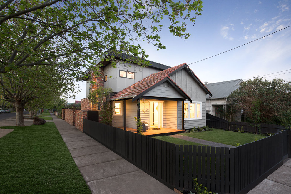 Photo of a mid-sized contemporary two-storey brick brown exterior in Melbourne with a gable roof.