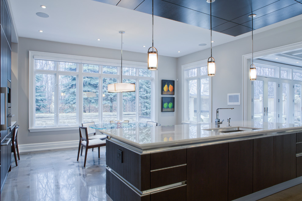 Inspiration for a large transitional u-shaped marble floor kitchen remodel in Toronto with flat-panel cabinets, dark wood cabinets, marble countertops, stainless steel appliances, an island and an undermount sink