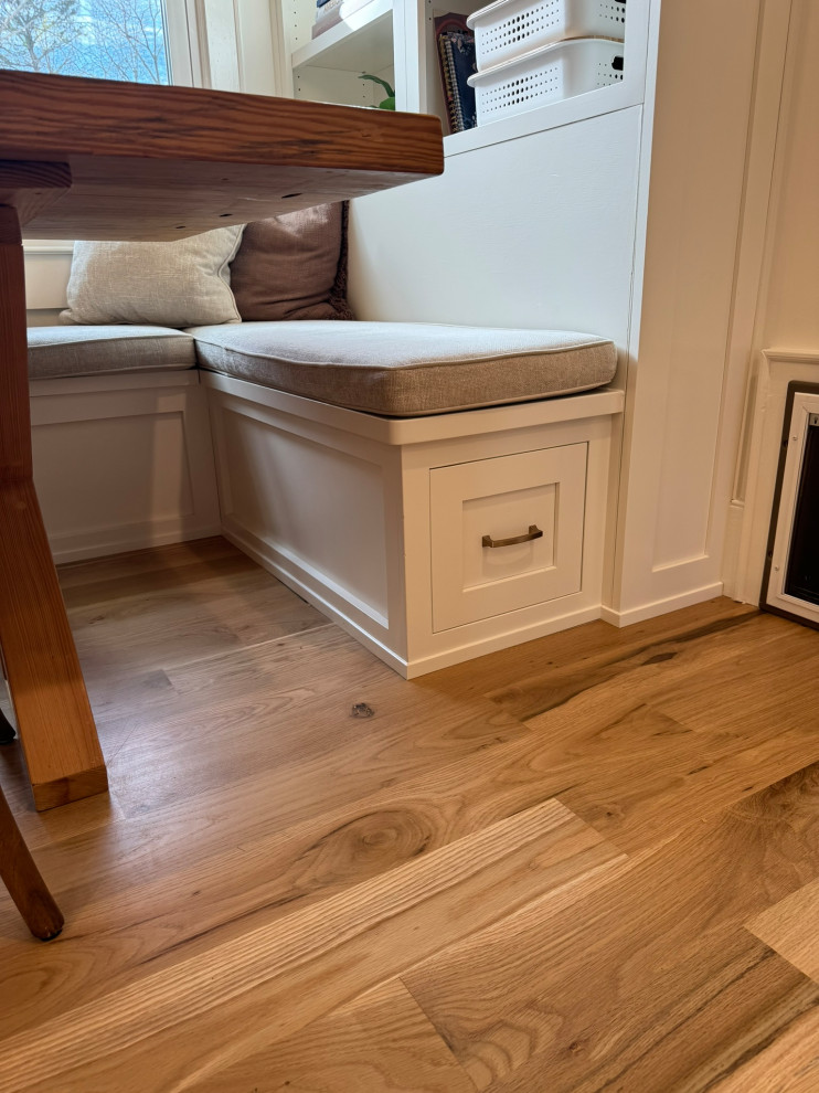 Inspiration for a mid-sized transitional l-shaped light wood floor, brown floor and wallpaper ceiling eat-in kitchen remodel in Atlanta with a farmhouse sink, shaker cabinets, white cabinets, granite countertops, white backsplash, stainless steel appliances, an island and white countertops