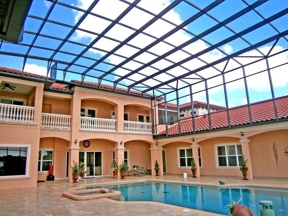 Large mediterranean indoor custom-shaped pool in Orlando with a hot tub.