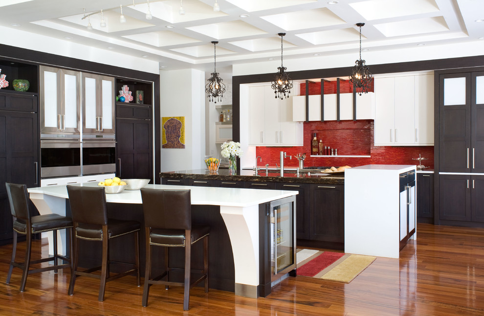 This is an example of a contemporary eat-in kitchen in Denver with red splashback, stainless steel appliances, shaker cabinets, quartz benchtops, medium hardwood floors, multiple islands, white benchtop and coffered.