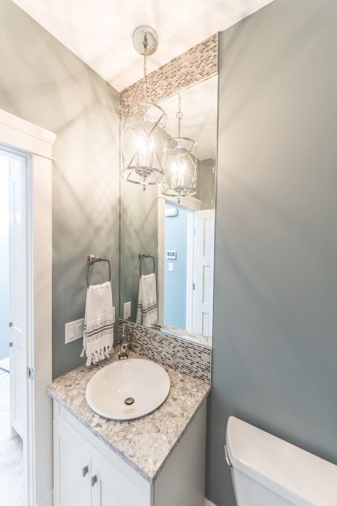 Inspiration for a small transitional powder room in Calgary with shaker cabinets, white cabinets, multi-coloured tile, mosaic tile, blue walls and engineered quartz benchtops.