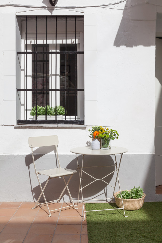 This is an example of a mid-sized scandinavian front yard patio in Madrid with a container garden and tile.