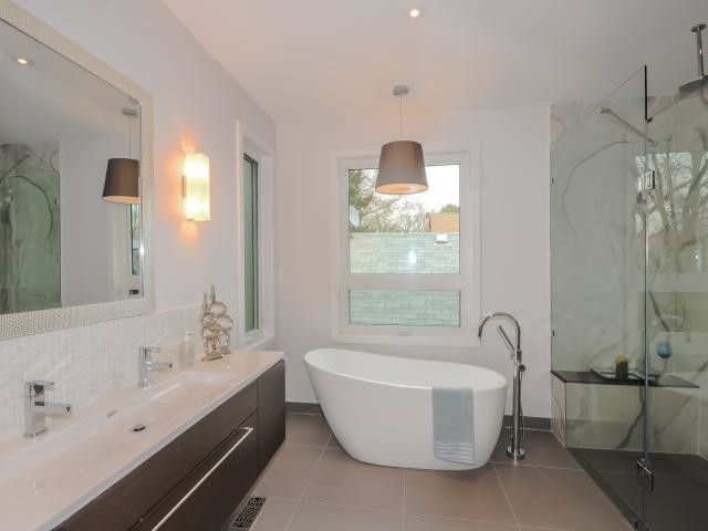 Large minimalist master white tile beige floor bathroom photo in Toronto with flat-panel cabinets, dark wood cabinets, white walls, an integrated sink and a hinged shower door
