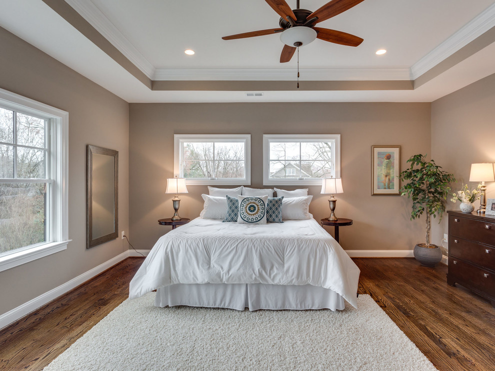 Photo of a transitional guest bedroom in DC Metro with grey walls and medium hardwood floors.