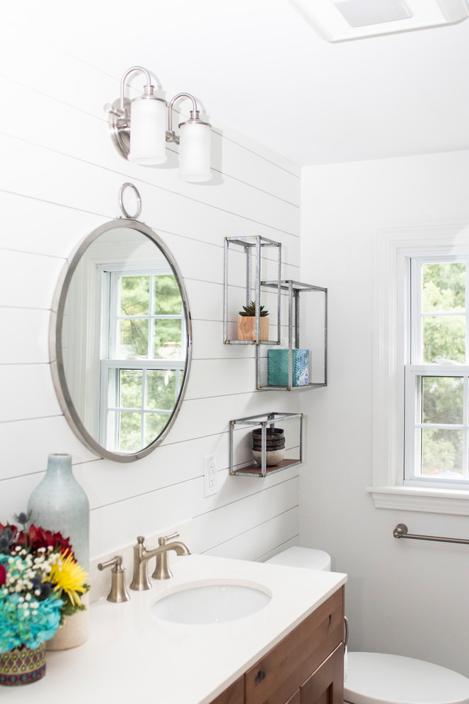 Design ideas for a mid-sized country master bathroom in Providence with recessed-panel cabinets, dark wood cabinets, a drop-in tub, a shower/bathtub combo, a two-piece toilet, white tile, subway tile, white walls, porcelain floors, an undermount sink, quartzite benchtops, white floor, a hinged shower door and white benchtops.