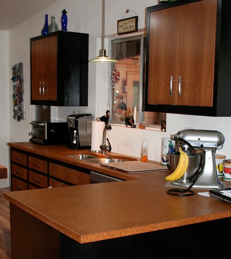 Mid-sized transitional medium tone wood floor kitchen photo in Phoenix with flat-panel cabinets, medium tone wood cabinets, wood countertops and stainless steel appliances