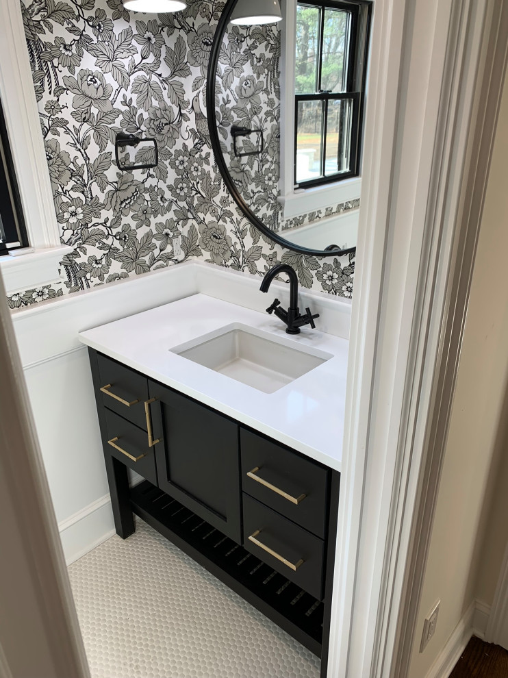 Country powder room in New York with flat-panel cabinets, dark wood cabinets, a two-piece toilet, white walls, an undermount sink, white benchtops, a built-in vanity and wallpaper.