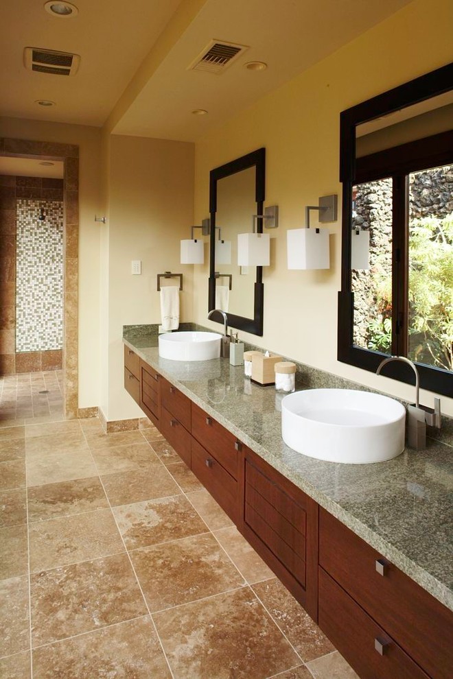 Tropical bathroom in Hawaii with a vessel sink, flat-panel cabinets, dark wood cabinets, an open shower, beige walls, an open shower and grey benchtops.