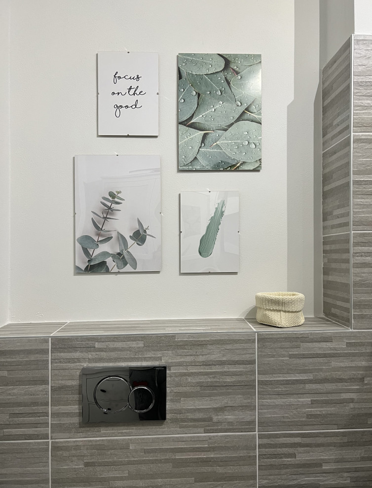 Photo of a medium sized modern cloakroom in Milan with flat-panel cabinets, grey cabinets, a two-piece toilet, grey tiles, porcelain tiles, white walls, porcelain flooring, an integrated sink, grey floors, white worktops and a freestanding vanity unit.