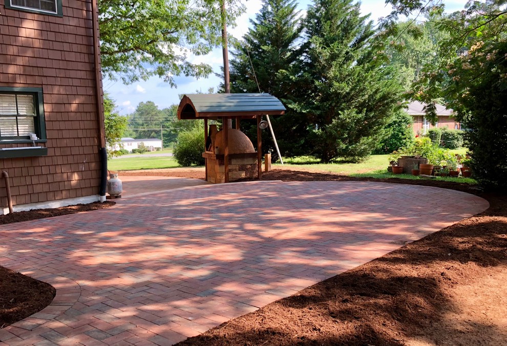 Inspiration for a large country backyard patio in Richmond with brick pavers and no cover.
