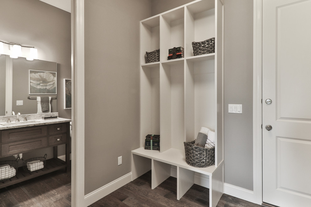 Inspiration for a mid-sized transitional u-shaped dark wood floor and brown floor entryway remodel in St Louis with an undermount sink, open cabinets, white cabinets, granite countertops, gray walls and a side-by-side washer/dryer