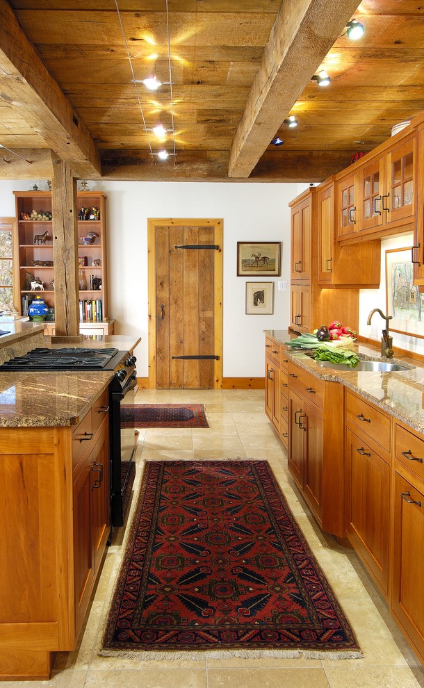 Inspiration for a mid-sized traditional galley open plan kitchen in Philadelphia with a double-bowl sink, shaker cabinets, medium wood cabinets, granite benchtops, panelled appliances, travertine floors, with island and beige floor.