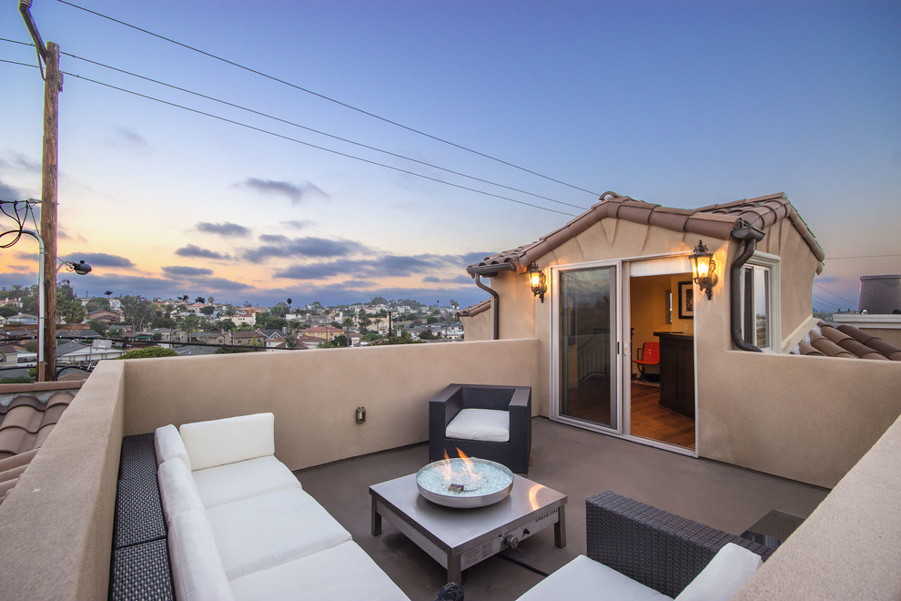 Mid-sized mediterranean rooftop and rooftop deck in Los Angeles with a fire feature and no cover.