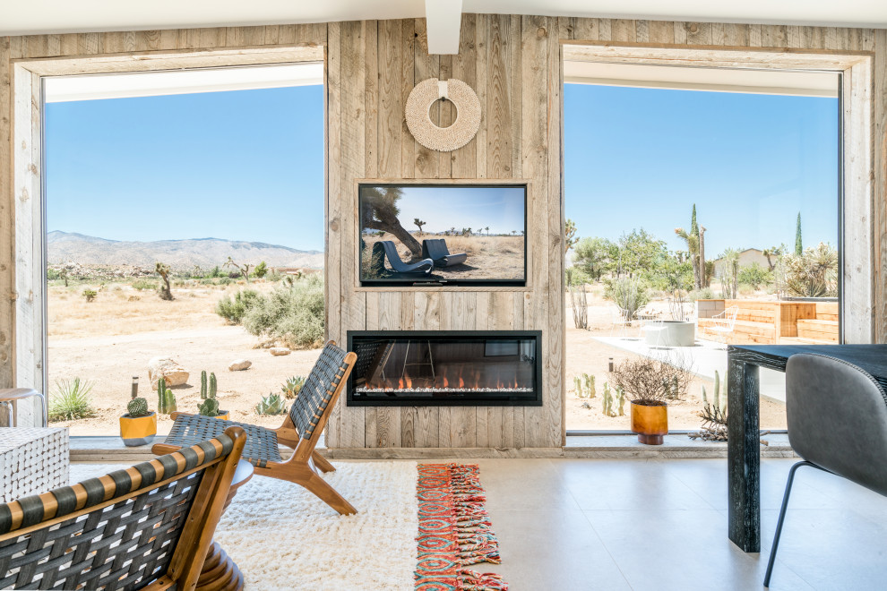 This is an example of a mid-sized contemporary formal open concept living room in Other with a ribbon fireplace, a wood fireplace surround, beige walls, concrete floors, a built-in media wall and brown floor.